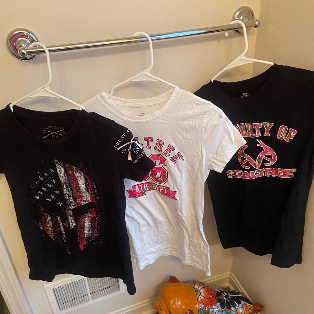 Three women’s cut small t-shirts.  One Grunt Style and two Real Tree.